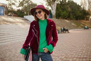 attractive woman in autumn style trendy outfit walking in street photo