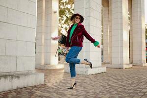 attractive woman in autumn style trendy outfit walking in street photo