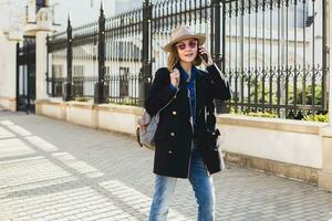 young stylish pretty woman smiling in dark blue coat photo