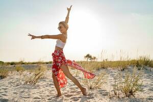 stylish attractive slim smiling woman on beach in summer style fashion trend outfit photo