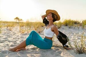 stylish attractive woman on beach in summer style fashion trend outfit happy having fun photo