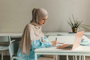 muslim woman in hijab working in office room photo