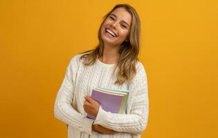young smiling pretty blond woman with books happy education photo