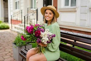 hermosa joven mujer en verano estilo atuendo sonriente contento caminando con flores en ciudad calle foto