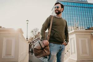 hipster man walking in street with bag photo