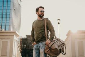 hipster man walking in street with bag photo