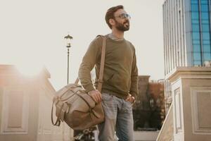 hipster man walking in street with bag photo