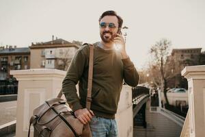 hipster man walking in street with bag photo