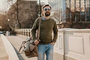 hipster man walking in street with bag photo