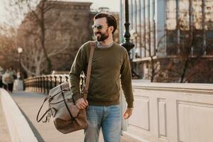 hipster man walking in street with bag photo