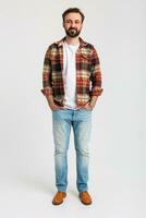 handsome bearded man in hipster outfit dressed in jeans and checkered shirt photo