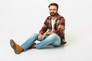 handsome bearded man in hipster outfit dressed in jeans and checkered shirt photo