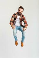 handsome bearded man in hipster outfit dressed in jeans and checkered shirt photo