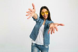 attractive woman dressed jeans and denim shirt wearing yellow sunglasses photo