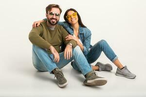 stylish couple sitting on floor in jeans photo