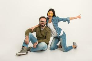 stylish couple sitting on floor in jeans photo