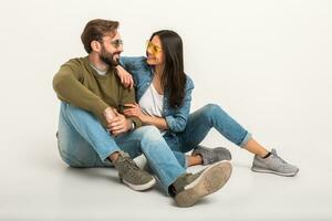 stylish couple sitting on floor in jeans photo