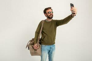 attractive stylish man traveler standing with bag photo