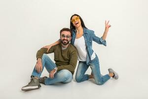 stylish couple sitting on floor in jeans photo