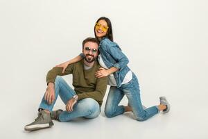 stylish couple sitting on floor in jeans photo