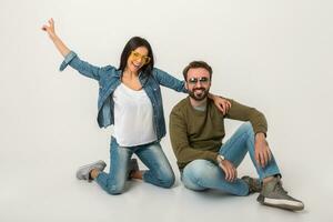 stylish couple sitting on floor in jeans photo