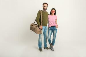 couple smiling woman and man in sweatshirt with travel bag photo