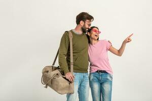 couple smiling woman and man in sweatshirt with travel bag photo