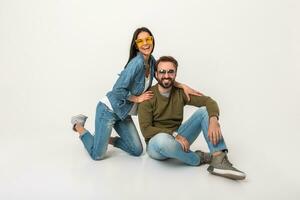 stylish couple sitting on floor in jeans photo