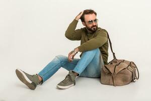 hansome bearded stylish man sitting on floor photo