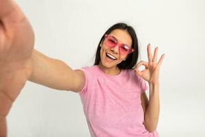 attractive woman in pink t-shirt and sunglasses photo