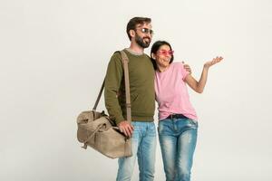 couple smiling woman and man in sweatshirt with travel bag photo