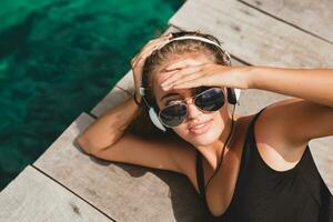 young slim woman laying on pier photo