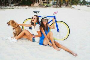 happy female friends having fun on tropical beach photo