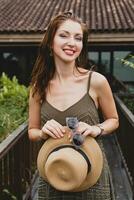 portrait of young attractive woman in elegant dress, straw hat, summer style photo