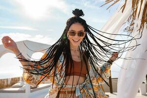 stylish pretty woman with african braids on sunny summer vacation photo