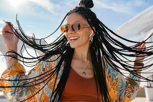 stylish pretty woman with african braids on sunny summer vacation photo