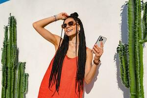 stylish pretty woman with african braids on sunny summer vacation photo