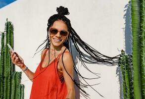 stylish pretty woman with african braids on sunny summer vacation photo