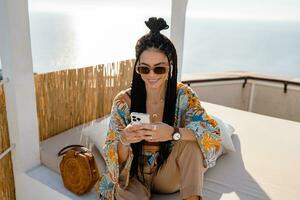 stylish pretty woman with african braids on sunny summer vacation photo