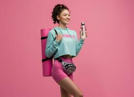 smiling happy beautiful woman in stylish sports outfit posing on pink background isolated in studio photo