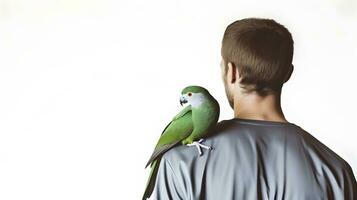 Beautiful green Monk parrot sitting on shoulder of man. photo