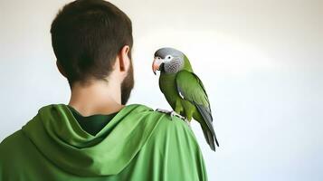 Beautiful green Monk parrot sitting on shoulder of man. photo