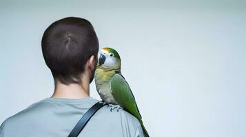 Beautiful green Monk parrot sitting on shoulder of man. photo