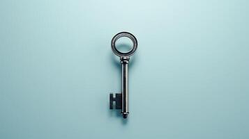 key with magnifying glass on blue background photo