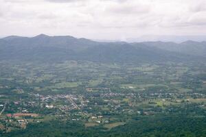 A village in Thailand surrounded by big green mountains. photo