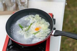 A pan to boil eggs on a camping gas stove photo