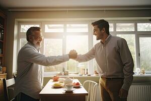 Businessman Shaking Hands With His Colleague In Kitchen At Home, An adult son and senior father indoors at home, making fist bump, AI Generated photo