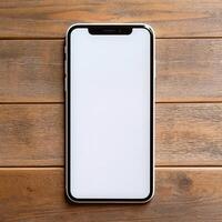 a white screen cell phone on a wooden table photo