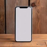 a white screen cell phone on a wooden table photo