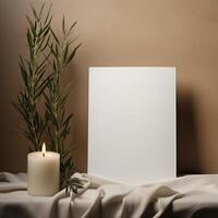 a white sheet of paper next to a candle and a plant photo